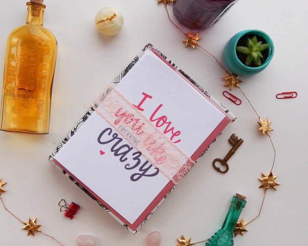 flat lay photograph of card that says I Love You Like Crazy with a bottle and succulent and skeleton key